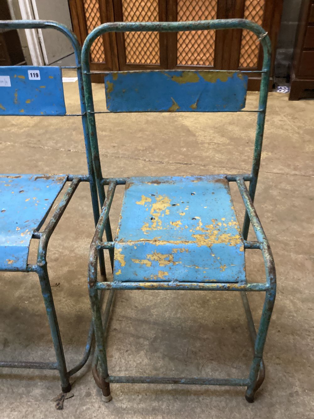 Four painted metal stacking chairs